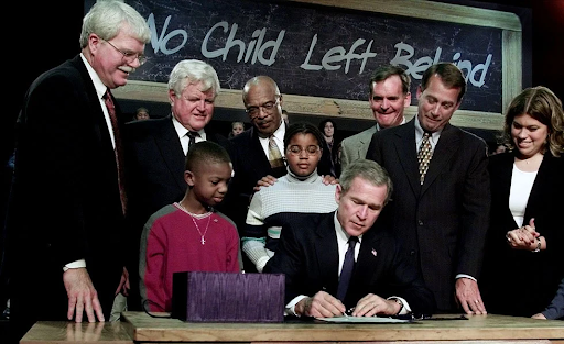 IMAGE: Forbes- President George W. Bush signs NCLB into law with widespread support, unknowingly changing the US education system for generations and leaving thousands of children behind.