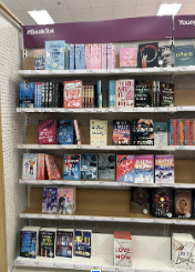 Brightly colored books litter a shelf titled “#Booktok”. The photo was taken Jan. 8 at a local Target. The shelf was one of at least 4 dedicated solely to #Booktok. None of the shelves clarifies that the books are mainly for adults. 
