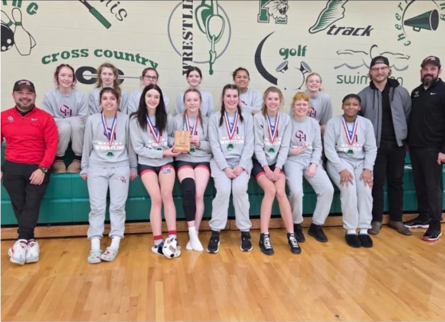 Front left: Kelley pictured with women's wrestling at Harrison High School