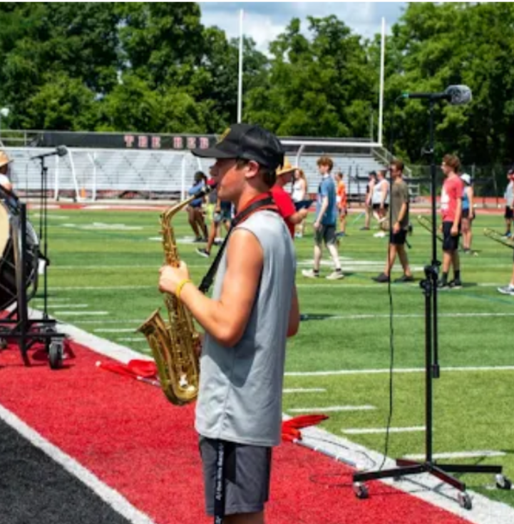Senior Aiden Spangler playing the alto saxophone for the Oak Hills marching band